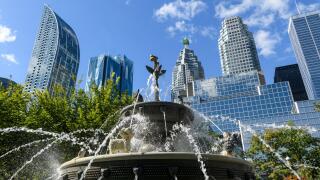 Berczy Park Dog Fountain and surrounding urban skyline cityscape of downtown Toronto, Ontario, Canada.