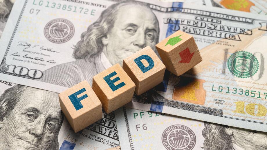 Wooden cubes with FED and up-down arrows over 100 usd. Fed rate hike concept to curb inflation