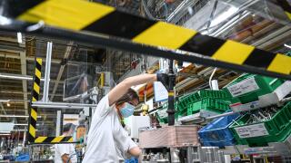 Friedrichshafen, Germany. 12th May, 2020. In plant two of the automotive supplier ZF Friedrichshafen, mechanic Vanessa is working on a transmission brake called ZF Intarder. ZF Friedrichshafen slowly restarts operations with protective and hygienic measur