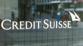 The logo of the Credit Suisse bank is written on the window of the bank in Bel-air Square in Geneva, Switzerland.