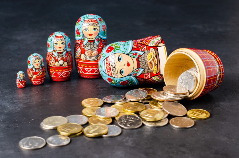 Traditional Russian toy matryoshka and money coins-adobe-2022