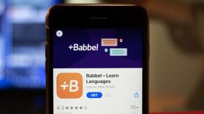 Los Angeles, California, USA - 16 April 2020: Babbel logo on screen close up. App store icon visible on phone display with blurry background