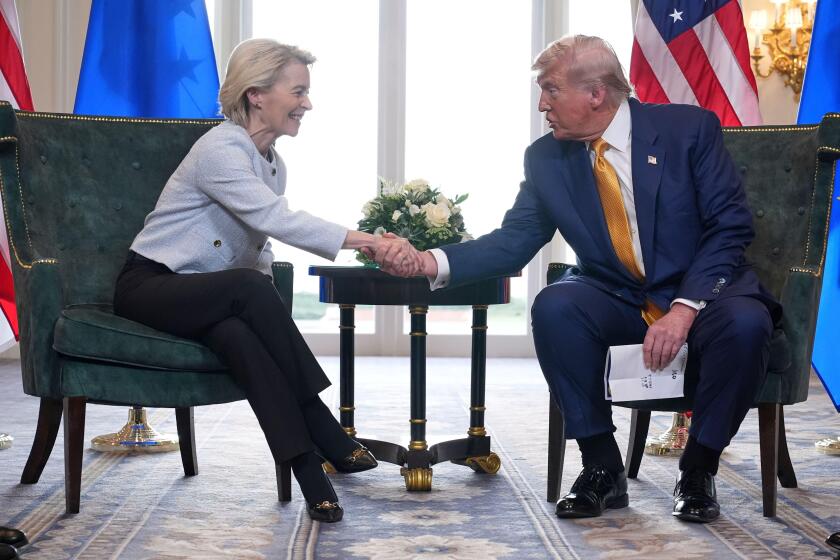 President Donald Trump and European Commission President Ursula von der Leyen shake hands after reaching a trade deal at the Trump Turnberry golf course in Turnberry, Scotland Sunday, July 27, 2025. (AP Photo/Jacquelyn Martin)