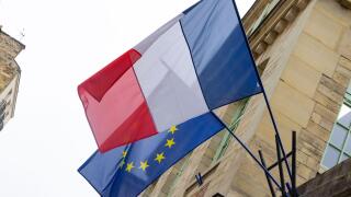The flag of France in front of European Union flag in Paris, France