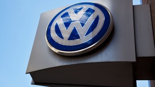 VW logo outside Volkswagen dealership London, UK