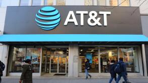 AT&T Store, 476-478 Fulton St, Brooklyn, NY. the gigantic logo of a telecommunications company and cellphone shop overlook shoppers on the Fulton Mall