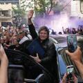 Argentine President Javier Milei waves to supporters upon arriving at a hotel in Rosario, Argentina, Thursday, Oct. 23, 2025. (AP Photo/Rodrigo Abd)