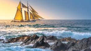 The schooner Anny owned by Rolf Munding under full sail sailing past Fistral in Newquay in Cornwall.