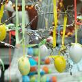 Decoration for Easter holiday celebration, selective focus. Eggs with ornament suspended in ribbons
