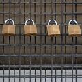 Four Master padlocks on a grill.