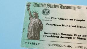 US Treasury illustrative check to illustrate American Rescue Plan Act of 2021 payment on blue background