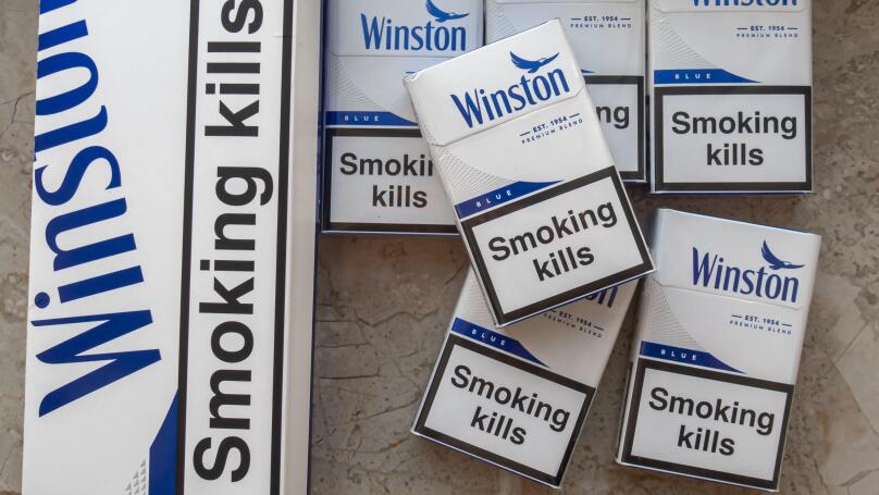 Winston blue cigarettes packaging features prominent health warnings in English, which state "Smoking kills" and "Smoking seriously harms you and othe