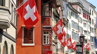 Old street in Zurich decorated with flags for the Swiss National