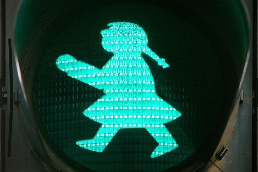 Pedestrian traffic light with green traffic light woman, Iceland, Reykjavik