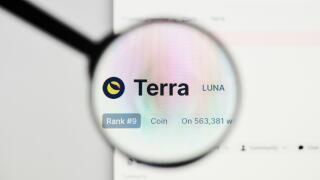 Milan, Italy - January 11, 2022: terra - LUNA website's hp.  terra, LUNA coin logo visible through a loope. Defi, ntf, cryptocurrency concepts illustr
