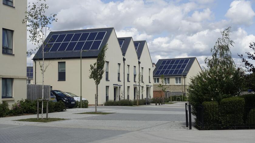 New contemporary sustainable low energy housing development with solar panels, rainwater harvesting, triple glazing, and attractive community spaces