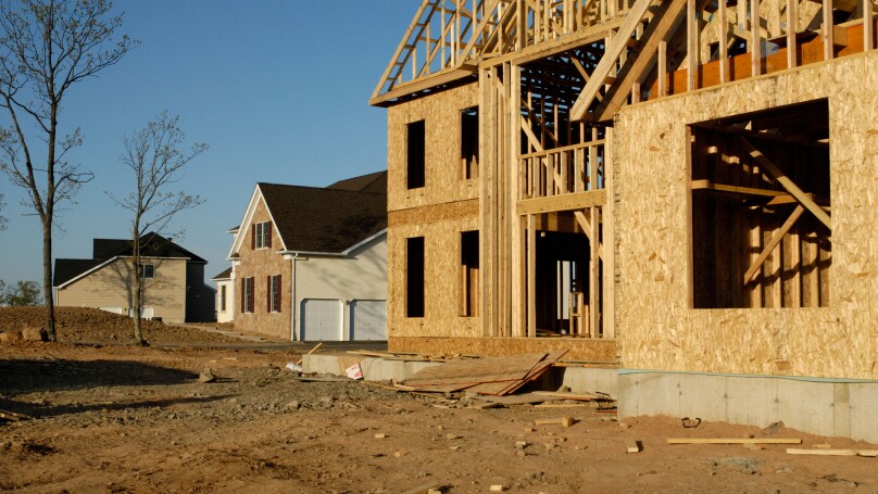 New suburban housing development under construction with finished and newly framed houses