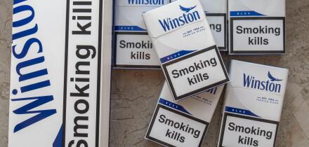 Winston blue cigarettes packaging features prominent health warnings in English, which state "Smoking kills" and "Smoking seriously harms you and othe