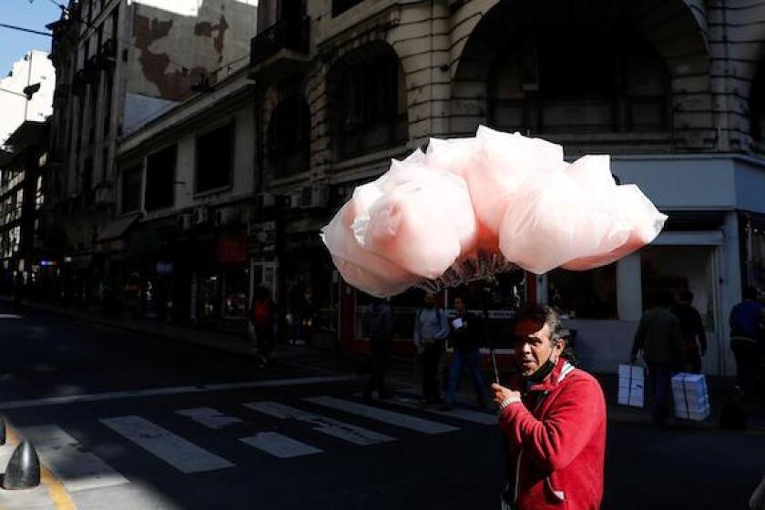 A man sells cotton candy as people protest against Argentine President Alberto Fernandez's economic measures, in Buenos Aires, Argentina May 12, 2022. REUTERS/Agustin Marcarian