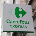 The Carrefour Express logo above a store in Bruges, Belgium.