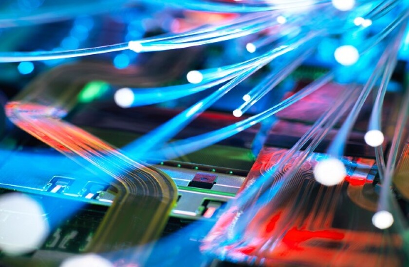 Fibre optic strands carrying data over electronic circuit board of laptop computer