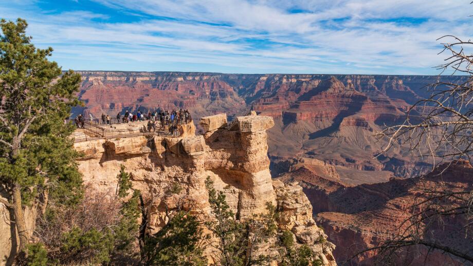Grand Canyon national park, Arizona. Tourists admiring the panoramic view from one of the view points on the south rim, in November, bright light