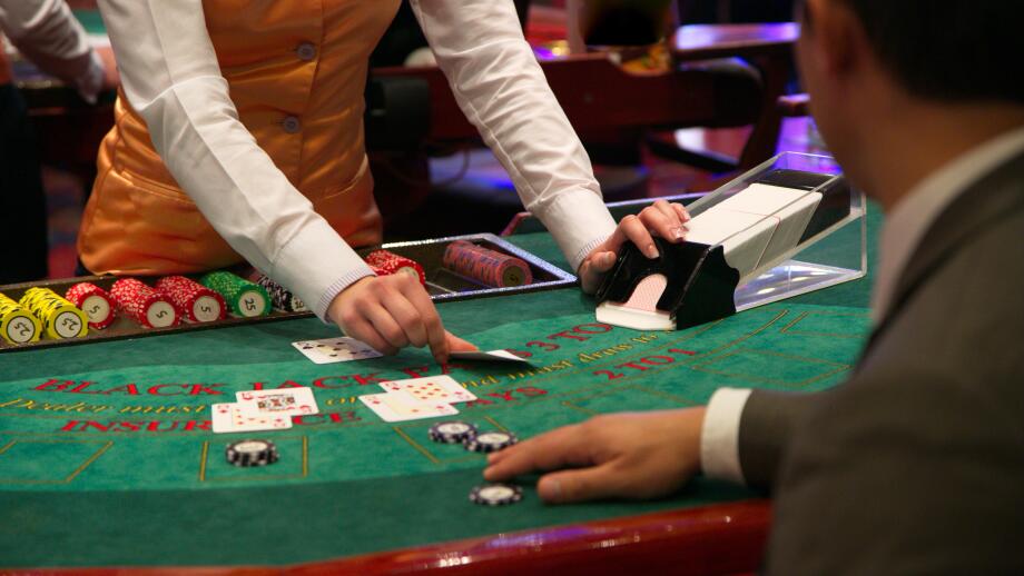 Dealer puts down a card on blackjack table
