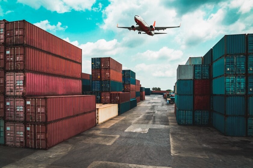 Cargo container for overseas shipping in shipyard with airplane in the sky .