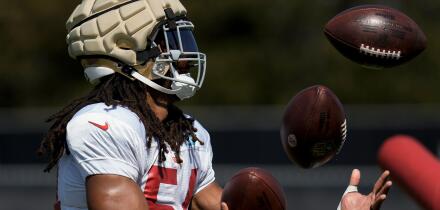 San Francisco 49ers linebacker Fred Warner juggles three footballs during NFL football training camp Friday, Aug. 4, 2023, in Santa Clara, Calif. (AP Photo/Godofredo A. Vasquez)