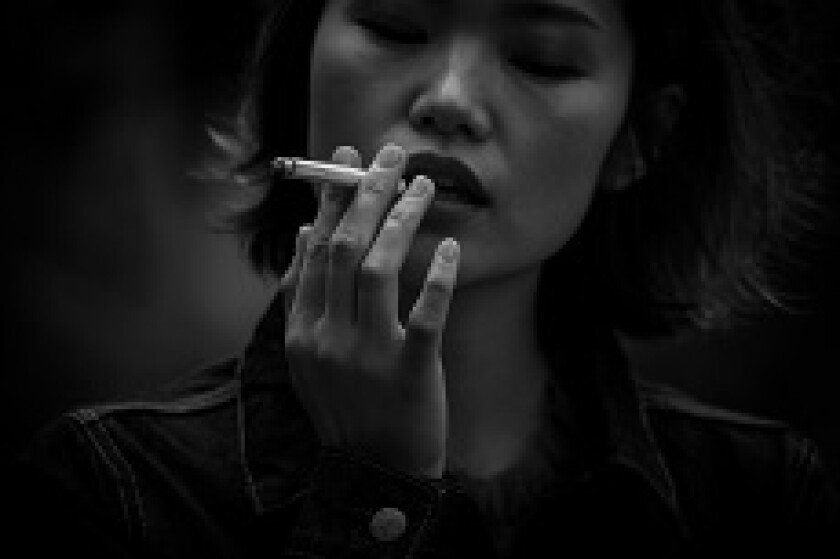 Japan Tobacco woman smoking from Adobe 18Nov19 230x150