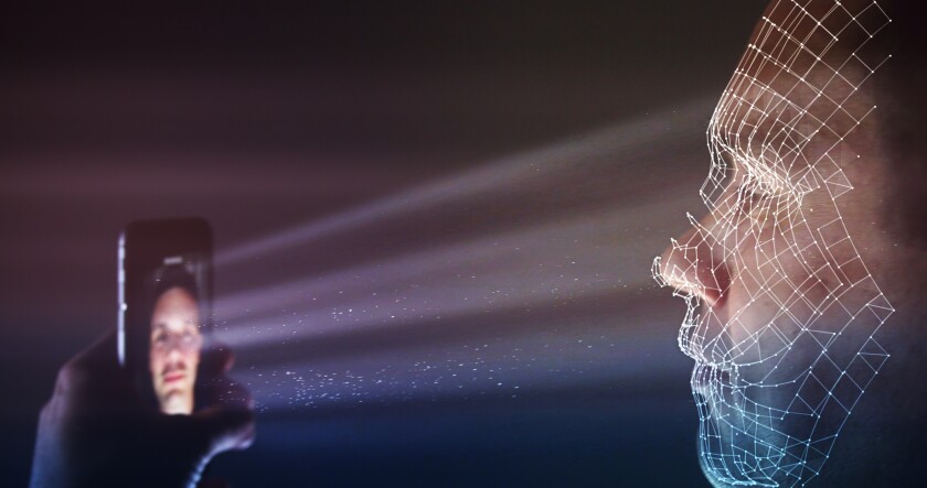 Male using latest smartphone technology for a biometric facial recognition unlock