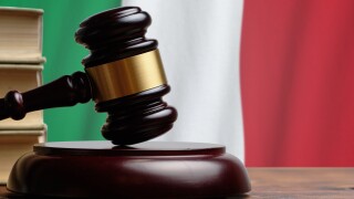 Justice and court concept in Italian Republic. Judge hammer on a Italy flag background