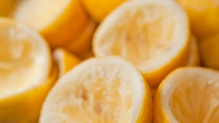 Lots of squeezed lemons with whole lemon after squeezing lemon's in a heap or pile of lots of lemons