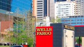 Wells Fargo branch in downtown Dallas, Texas with skyscrapers and office buildings in the background.