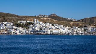 View from the sea to the town of Adamas with Plaka on a hill in the distance, Adamas, Milos, South Aegean, Greece, Europe