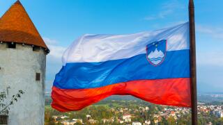 Bled Castle with the Slovenian flag, Bled, Slovenia, October 2014.