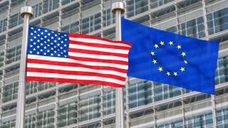 US and European flags waving in the wind (3D rendered)