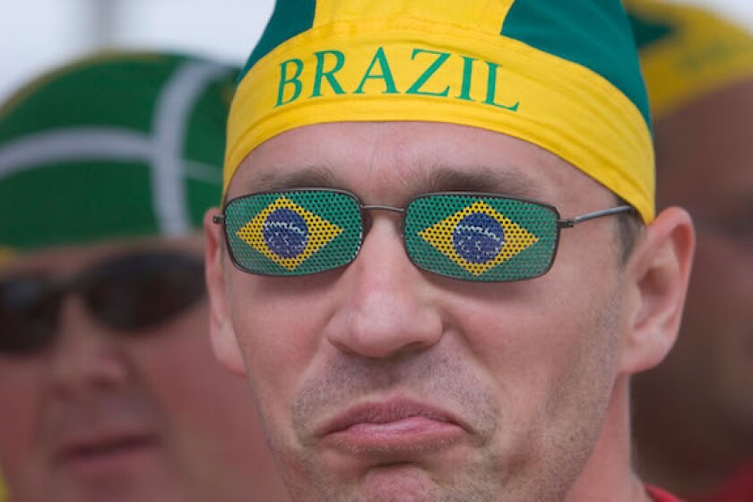 A Brazilian football fan, sceptically viewing the world cup match Brazil vs Ghana (3:0) at a public viewing event in Dortmund