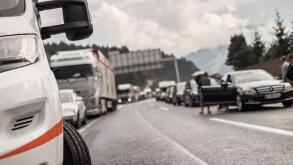Typical scene on European highways during summer holiadays rush hour. A traffic jam with rows of cars tue to highway car accident. Empty emergency
