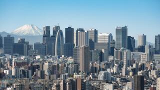 The view of the skyscrapers of Shinjuku and central Tokyo with the snow-covered peak of Mount Fuji in the distance.