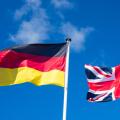 Flags of Germany and United Kingdom against blues sky