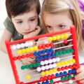 brother and sister playing with abacus