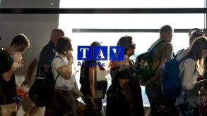 People waiting in line for departure in an airport's hallway