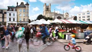 Cambridge Market on a busy saturday in Summer.Tourists and locals alike visit the market and are blurred through a long exposure
