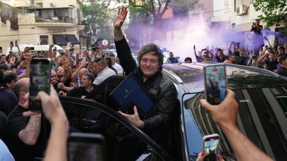 Argentine President Javier Milei waves to supporters upon arriving at a hotel in Rosario, Argentina, Thursday, Oct. 23, 2025. (AP Photo/Rodrigo Abd)