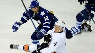 Toronto Maple Leafs Kris Versteeg, left, collects an elbowing penalty against Edmonton Oilers' Taylor Hall during third period NHL action in Edmonton, Alberta, on Tuesday, Dec. 14, 2010. (AP Photo/THE CANADIAN PRESS/John Ulan)