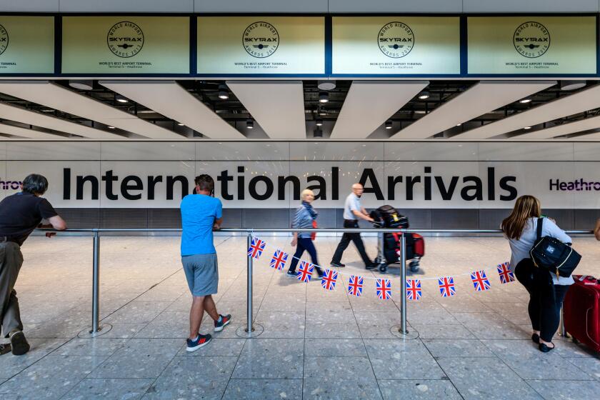 People Waiting At The Terminal 5 International Arrivals Hall, Heathrow Airport, London, UK