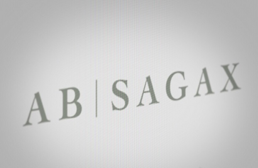 Logo of the public company Sagax displayed on a computer screen in close-up. Credit: PIXDUCE