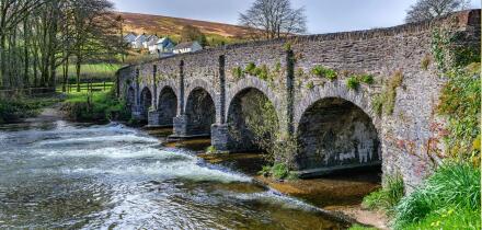 Six arched bridge over the River Barle as it flows through the village of Withypool in Exmoor National Park Somerset UK