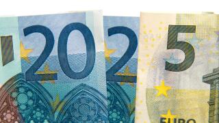 CLose up on 2025 written with euros bank notes, finances, earnings and budget concept